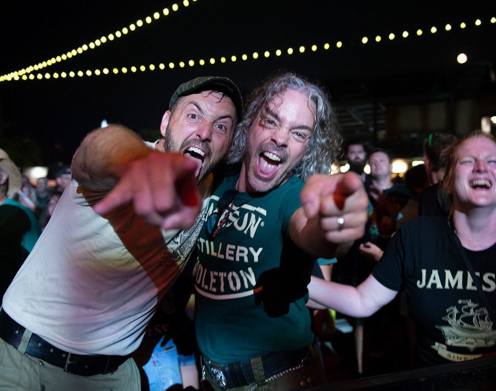 Two men excitingly pointing at the camera